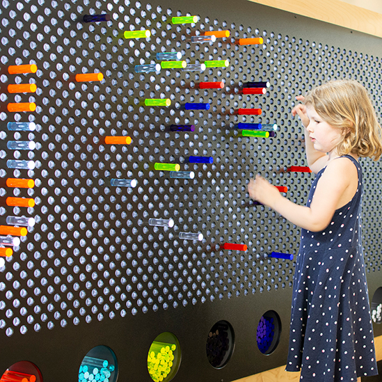 girl playing with a light bright